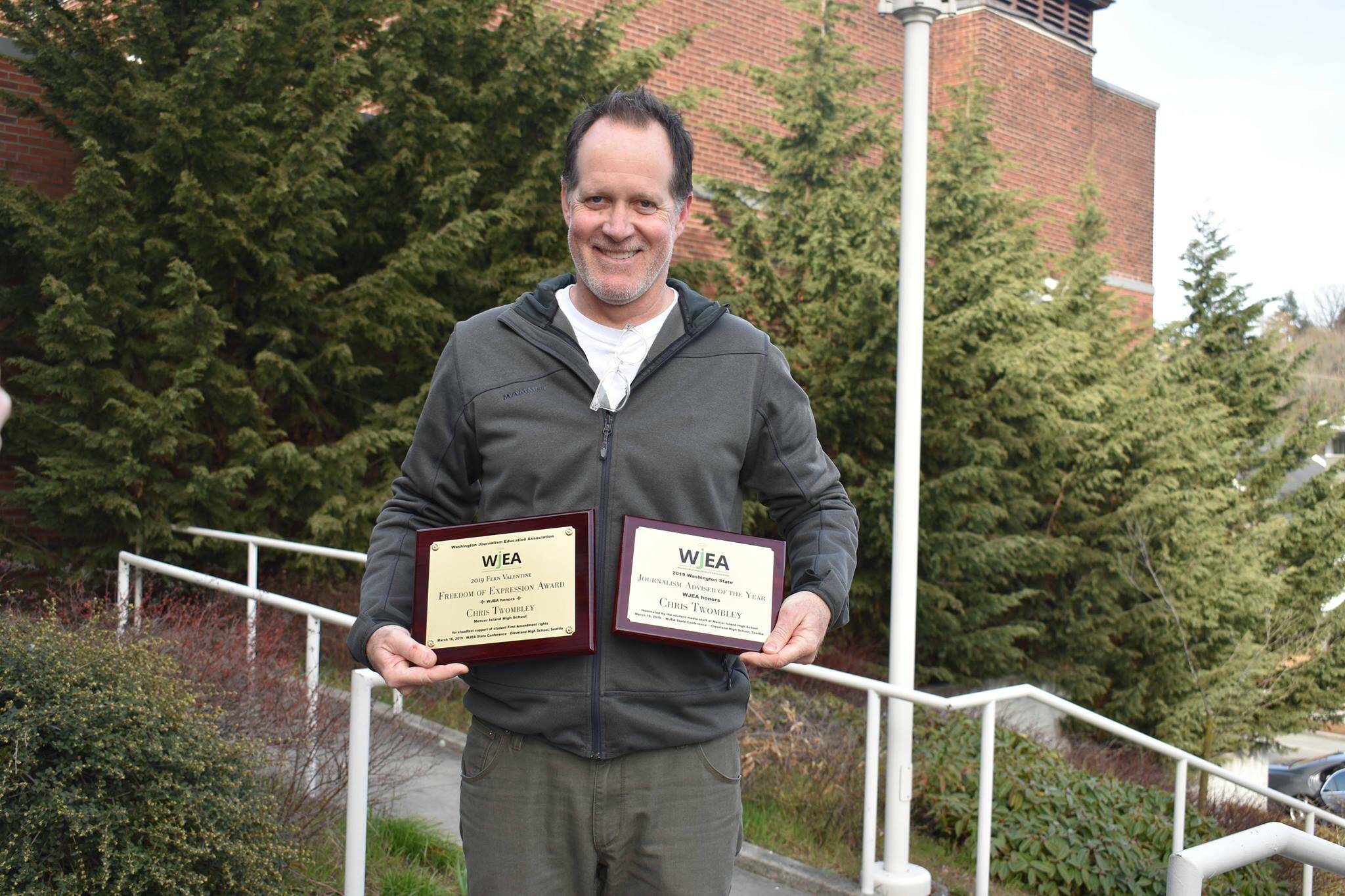 Former Mercer Island High School teacher Chris Twombley poses with a pair of awards for the schools student newspaper in March 2019. This photo was posted on the school districts Facebook page. Courtesy photo