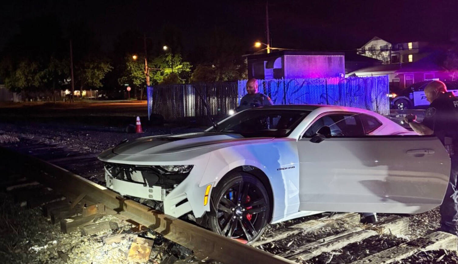 A Chevy Camaro gets stuck on the railroad tracks Friday night, Aug. 22 in Kent near West Harrison Street after a pursuit by the Washington State Patrol. COURTESY PHOTO, Washington State Patrol