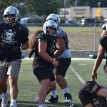Kentwood linebacker gives a smile during team drills at Kentwood football practice. Ben Ray / The Reporter