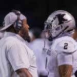 Photos provided by Robby Mullikin
New Kentwood Coach Quincey Davidson Jr. and a Kentwood player on the sidelines.