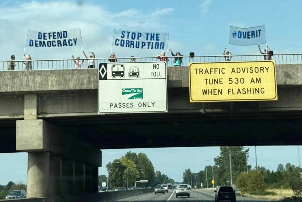 People protest along the South 277th Street overpass Sept. 1 on State Route 167 on the Kent/Auburn border. COURTESY PHOTO, Indivisible Auburn WA