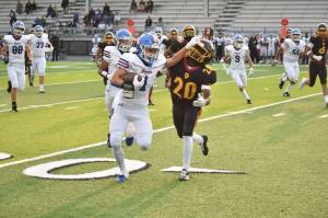 Adonai Garza stiff-arms a Thomas Jefferson defender. Ben Ray / The Reporter