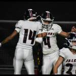 Maurice Molipe Ute-Galeai (14) and Lincoln Moore (4) celebrate a Kentlake Touchdown. Ben Ray / The Reporter