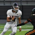 Lincoln Moore runs the ball for Kentlake against Thomas Jefferson. Ben Ray / The Reporter