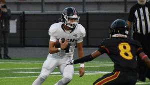 Lincoln Moore runs the ball for Kentlake against Thomas Jefferson. Ben Ray / The Reporter