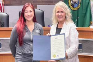 Jasmyne Faborito, organizer of the Torklift Central Turkey Challenge, left, and Kent Mayor Dana Ralph during the Oct. 7 City Council meeting to recognize the annual event to raise money and food for the Kent Food Bank. COURTESY PHOTO, City of Kent