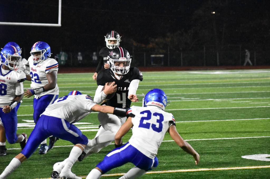 Lincoln Moore runs the ball for Kentlake. Ben Ray / The Reporter