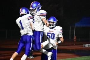 Adonai Garza and Luke Garza celebrate a touchdown for Kent-Meridian. Ben Ray / The Reporter