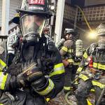 A Puget Sound Fire firefighter rescues a cat from a Nov. 19 fire. COURTESY PHOTO, Puget Sound Fire