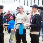 Community members enjoy food from Project Feast at Star Lake station during the celebration of the new light rail station.