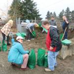 Maplewood residents and helpers fill up sandbag after sandbag at the county public sandbag station in the Highlands to keep the water from getting into their neighborhood. Photo by Bailey Jo Josie/Sound Publishing.