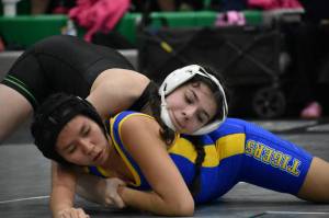 Karina Quebrado from Kentwood wrestles in her home gym. Ben Ray / The Reporter