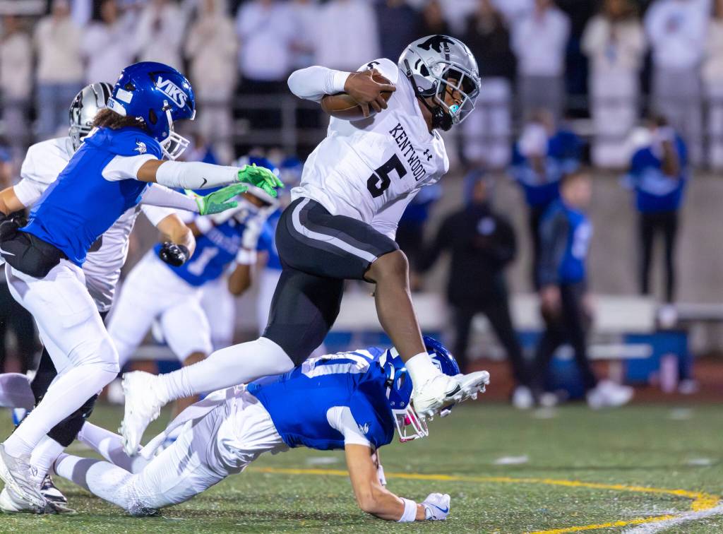 Marquise Jones leaps over a Curtis defender for Kentwood. Photo provided by Robby Mullikin