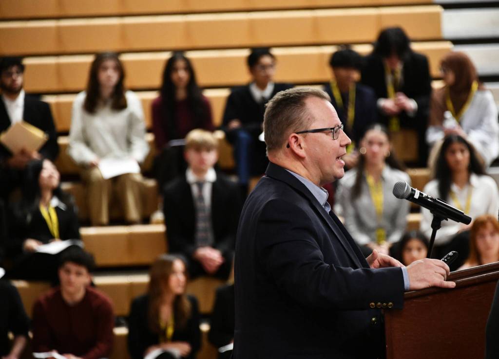 Washington State Office of Superintendent of Public Instruction (OSPI) Head Chris Reykdal speaks at the regional education funding town hall on Jan. 7 at Newport High School in Bellevue as copious student speakers sit in the background awaiting their turns at the mic. Andy Nystrom/ staff photo