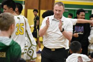 Kentridge head coach Zac Webb claps as he wins his biggest game as the Chargers' head coach. Ben Ray / The Reporter