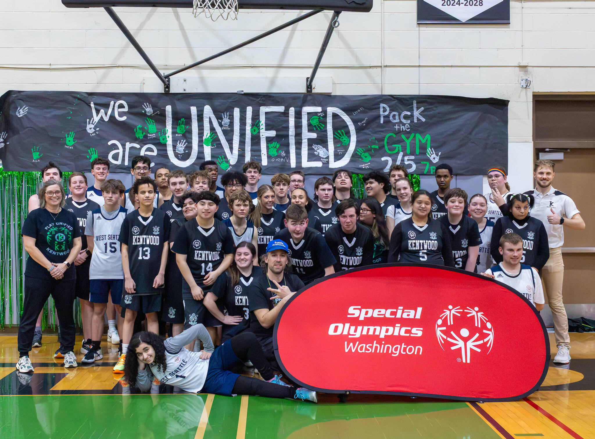 Kentwood players and coaches post for a picture with West Seattle. Photo provided by Robby Mullikin