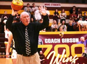 PHOTO BY KEVN HANSON 
Chris Gibson acknowledges the cheering crowd during a White River High ceremony recognizing his 700th career victory.