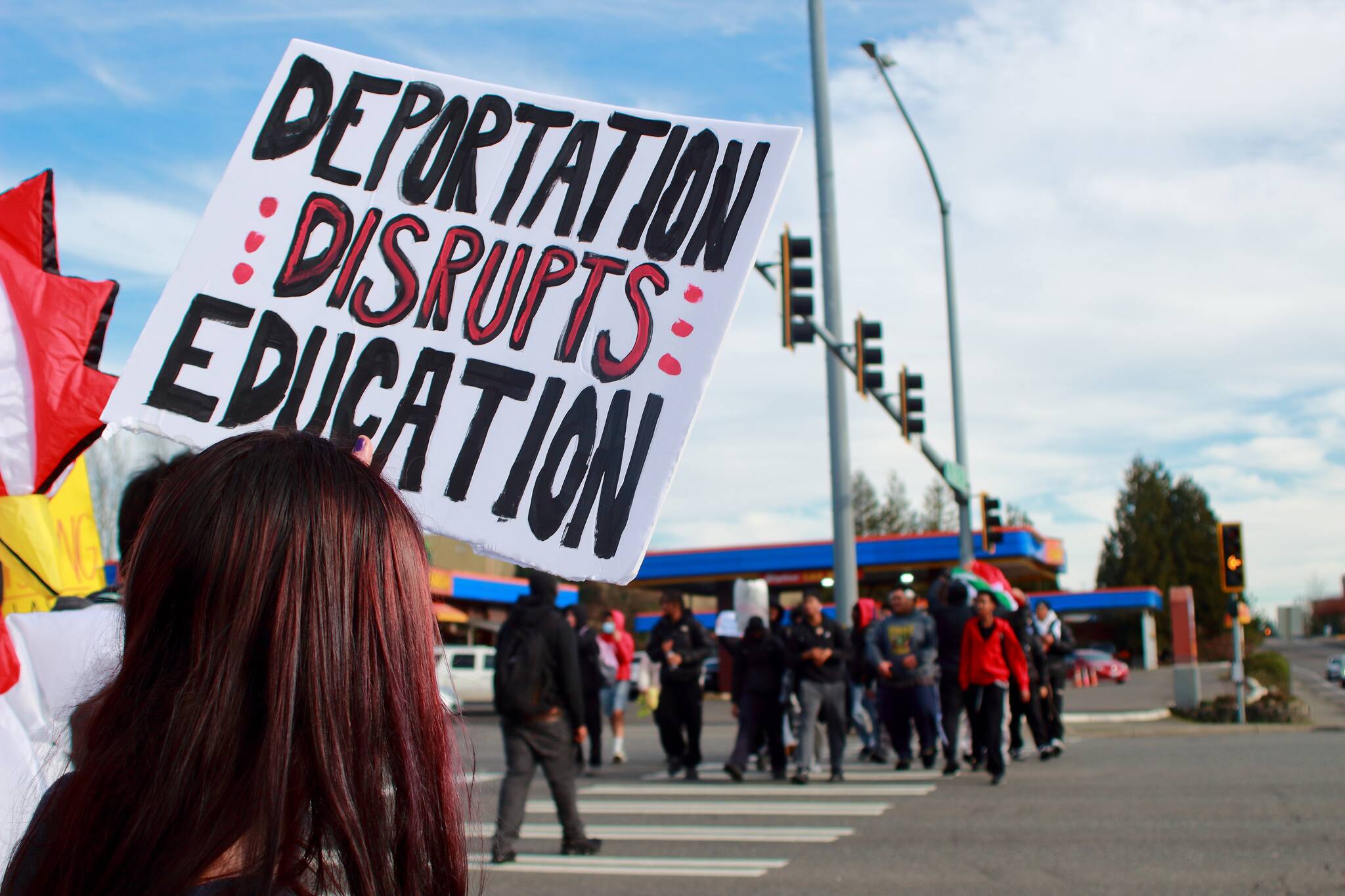 A student holds a sign that reads deportation disrupts education during a student-led protest that began at Federal Way High School. Photo by Keelin Everly-Lang / the Mirror.