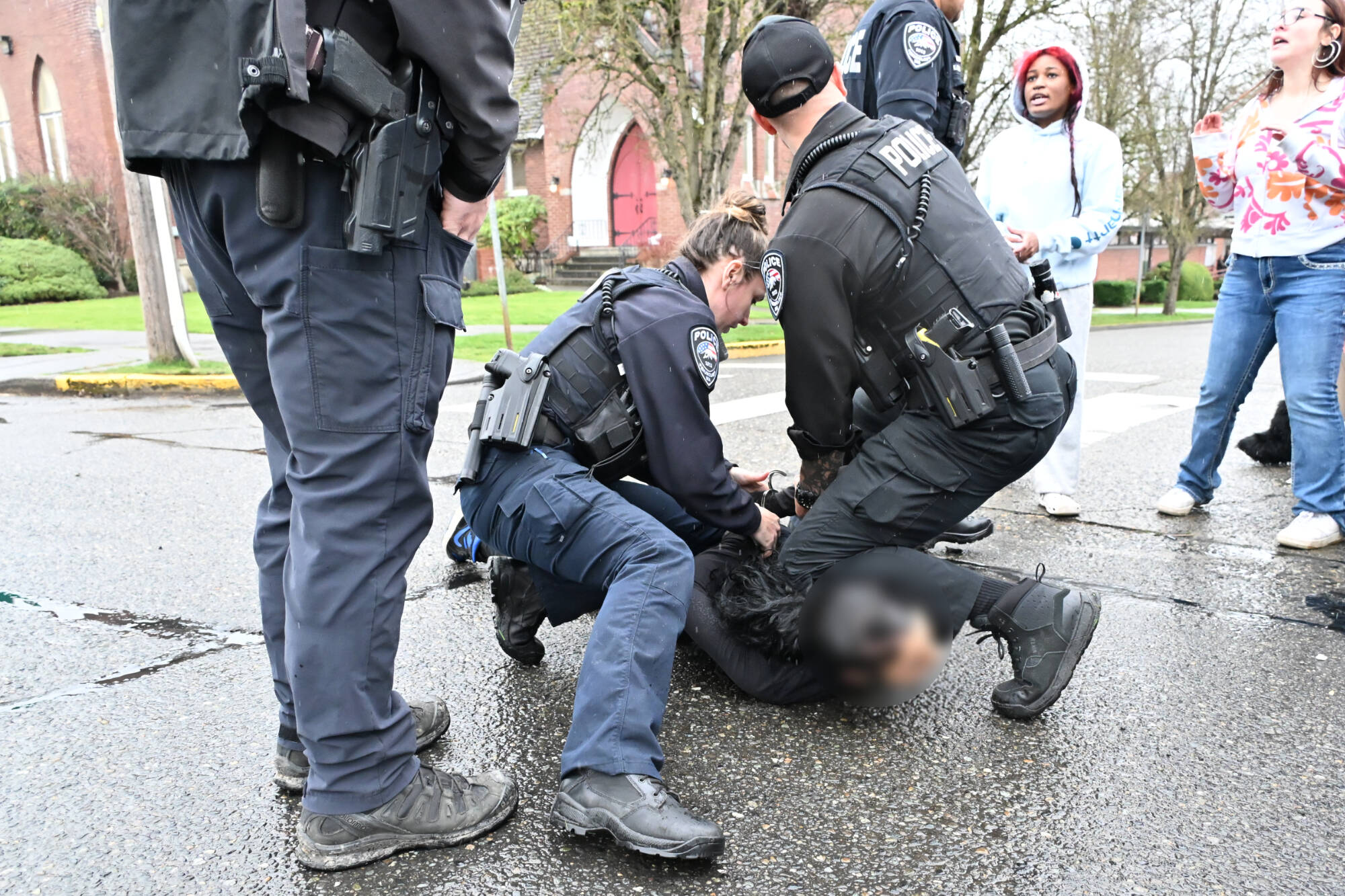 The student who allegedly assaulted a man at the walkout was arrested by the Enumclaw Police Department on Porter Avenue. The Courier-Herald does not typically identify students accused of a crime, and the photo has been blurred. Photo by Ray Miller-Still
