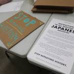 A sign created by a community member rests next to an updated version of Executive Order 9066 from Tsuru for Solidarity, this time calling for descendants and survivors to stand up against state violence against immigratn communities. Photo by Bailey Jo Josie/Sound Publishing