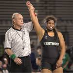 Dayna Vi has her hand raised as the winner of her state tournament. Ben Ray / The Reporter