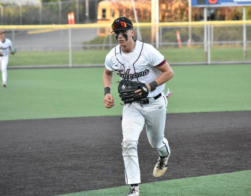 Lincoln Moore runs off the field after making a play at third base for Kentlake. Ben Ray / The Reporter