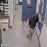 Rena Flaherty holds onto a wall for support as she walks down a jail corridor. COURTESY PHOTO, Court documents