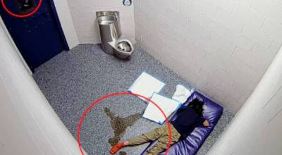 Rena Flaherty in a city of Kent jail cell, where she died April 22, 2025. A corrections officer looks through the cell door window. COURTESY PHOTO, Court documents