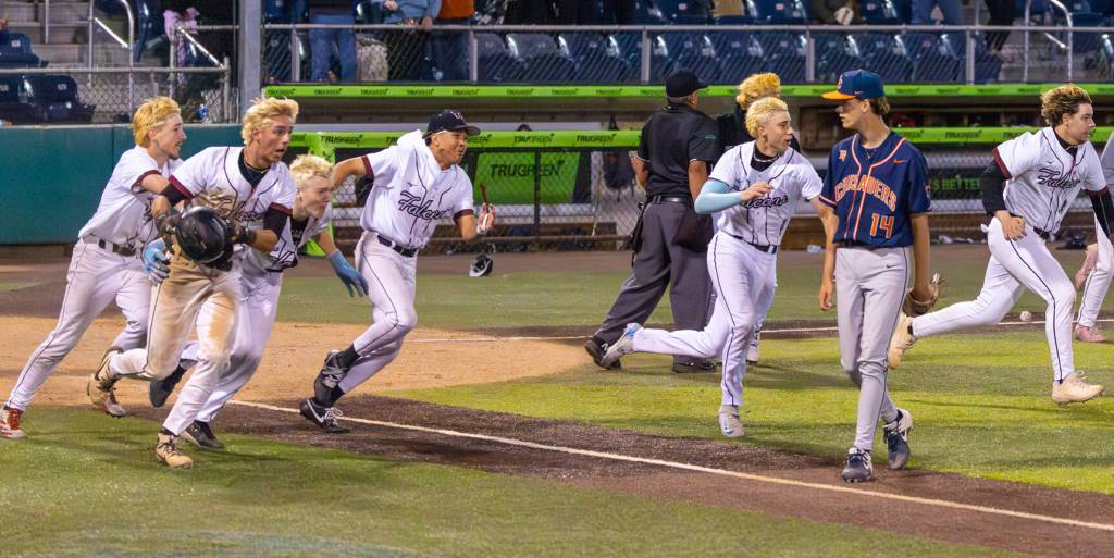 Kentlake players race to celebrate the championship win. Photo provided by Robby Mullikin.