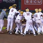 The party is on at second base as Kentlake teammates swarm Matthew Ledbetter. Photo provided by Robby Mullikin.