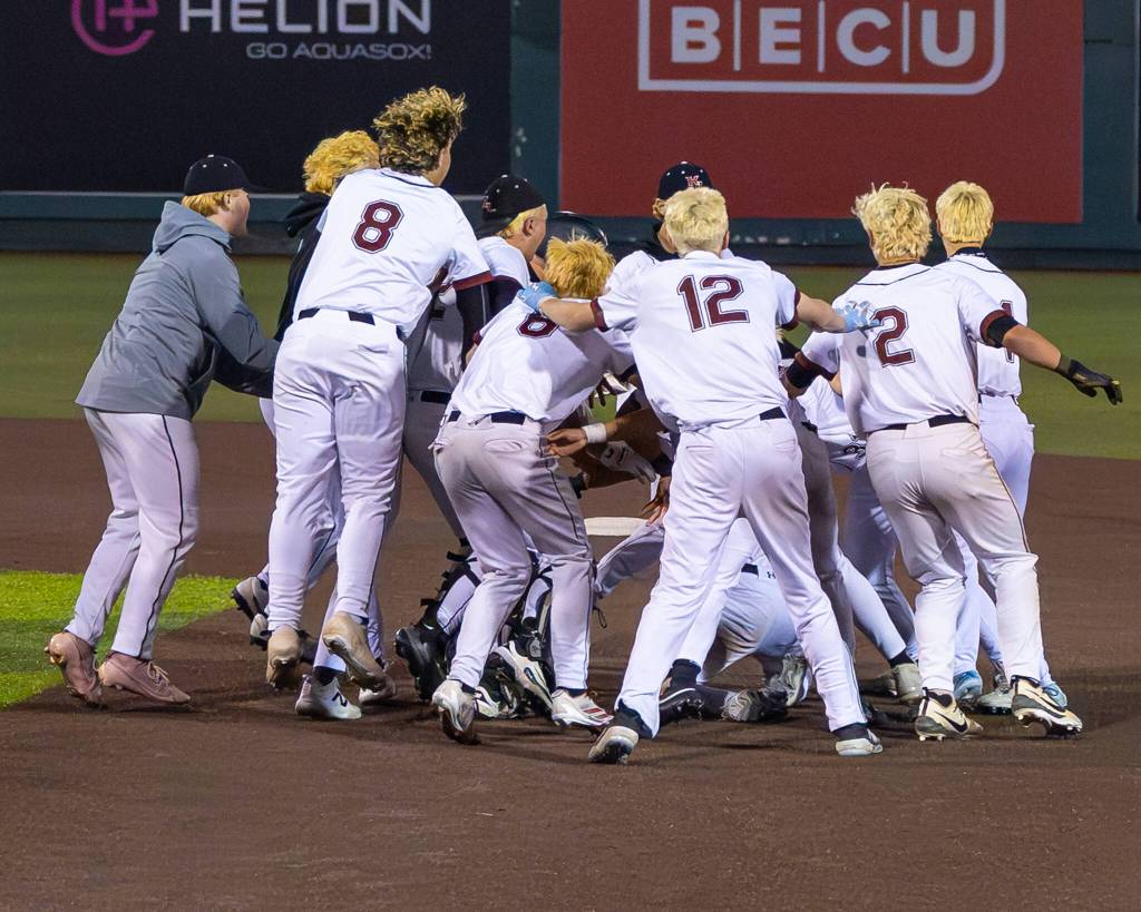 The party is on at second base as Kentlake teammates swarm Matthew Ledbetter. Photo provided by Robby Mullikin.