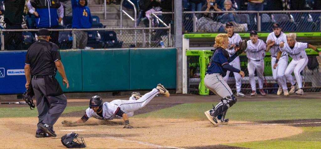 Lincoln Moore dives into home to score the winning run against Eastside Catholic. Photo provided by Robby Mullikin.