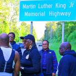 Gwen Allen-Carston leads a celebration May 26 of the newly installed Martin Luther King Jr. Memorial Highway sign along Benson Road in Renton. COURTESY PHOTO, Kent Black Action Commission