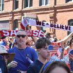 Fans hoist scarves as the march to Seattle Stadium continued. Ben Ray / The Reporter